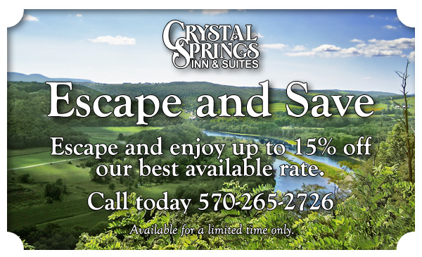 text stating Enjoy spectacular views, local attractions, and affordable rates at the Crystal Springs Inn and Suites. Book your Towanda Hotel Today and Save! over rolling green hills